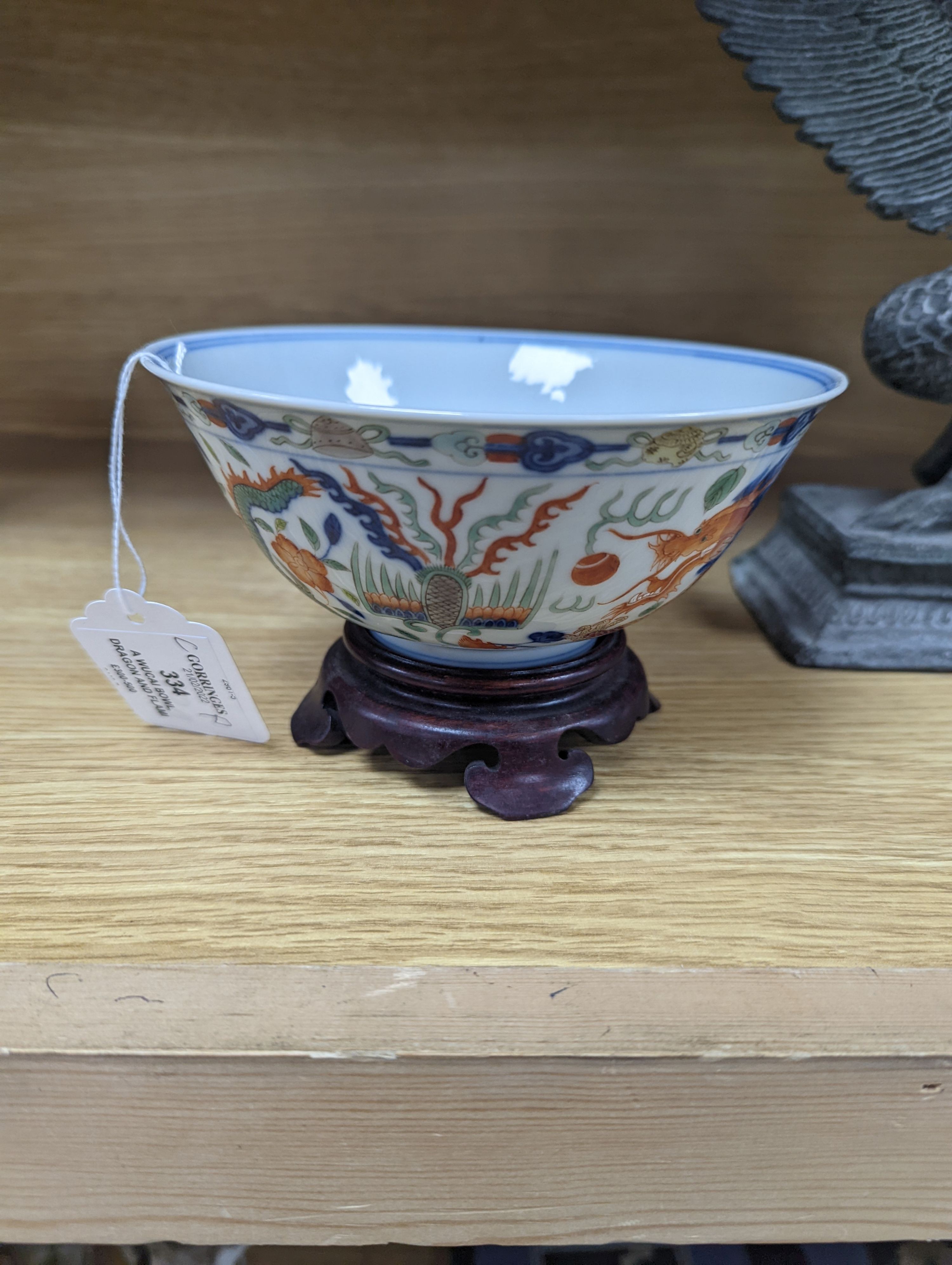 A Wucai bowl, dragon and flamingo pearl decoration, Jiaqing mark, on wood stand. 16cm diameter